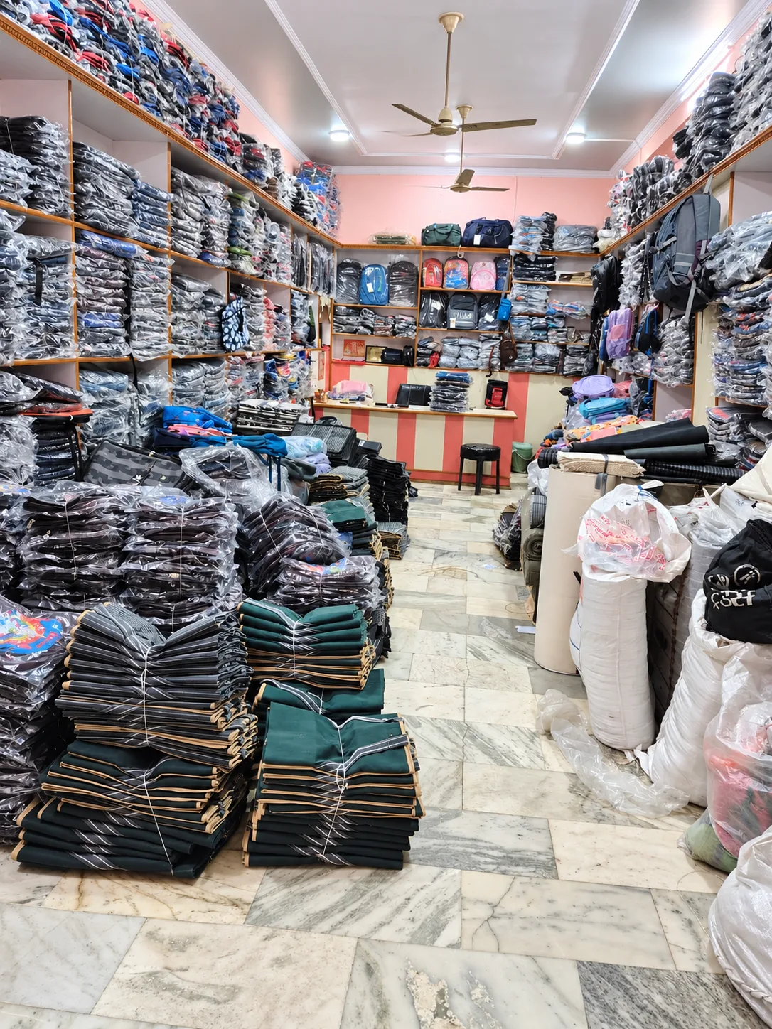 Ground-floor office with shelves of packed bags and bundled bag stock